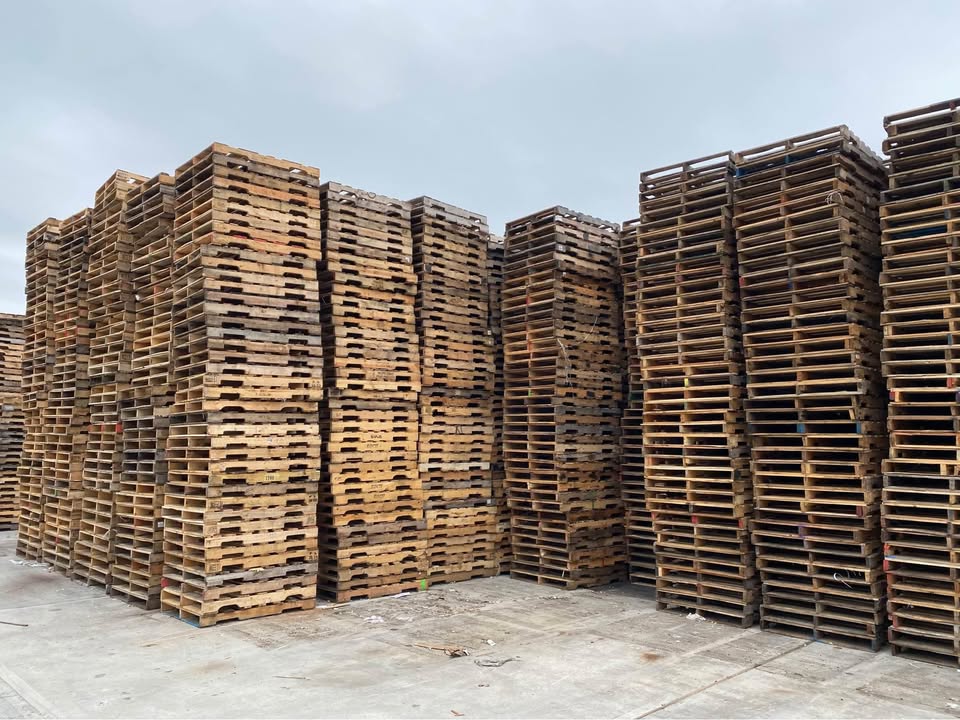 Quality pallets stacked and ready for delivery at All American Recycling warehouse